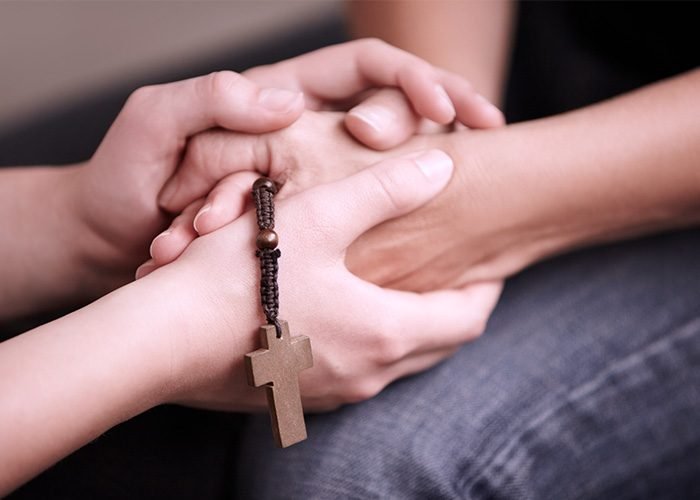 Holding hands, prayer together with beads and help for religion, trust and spiritual hope.